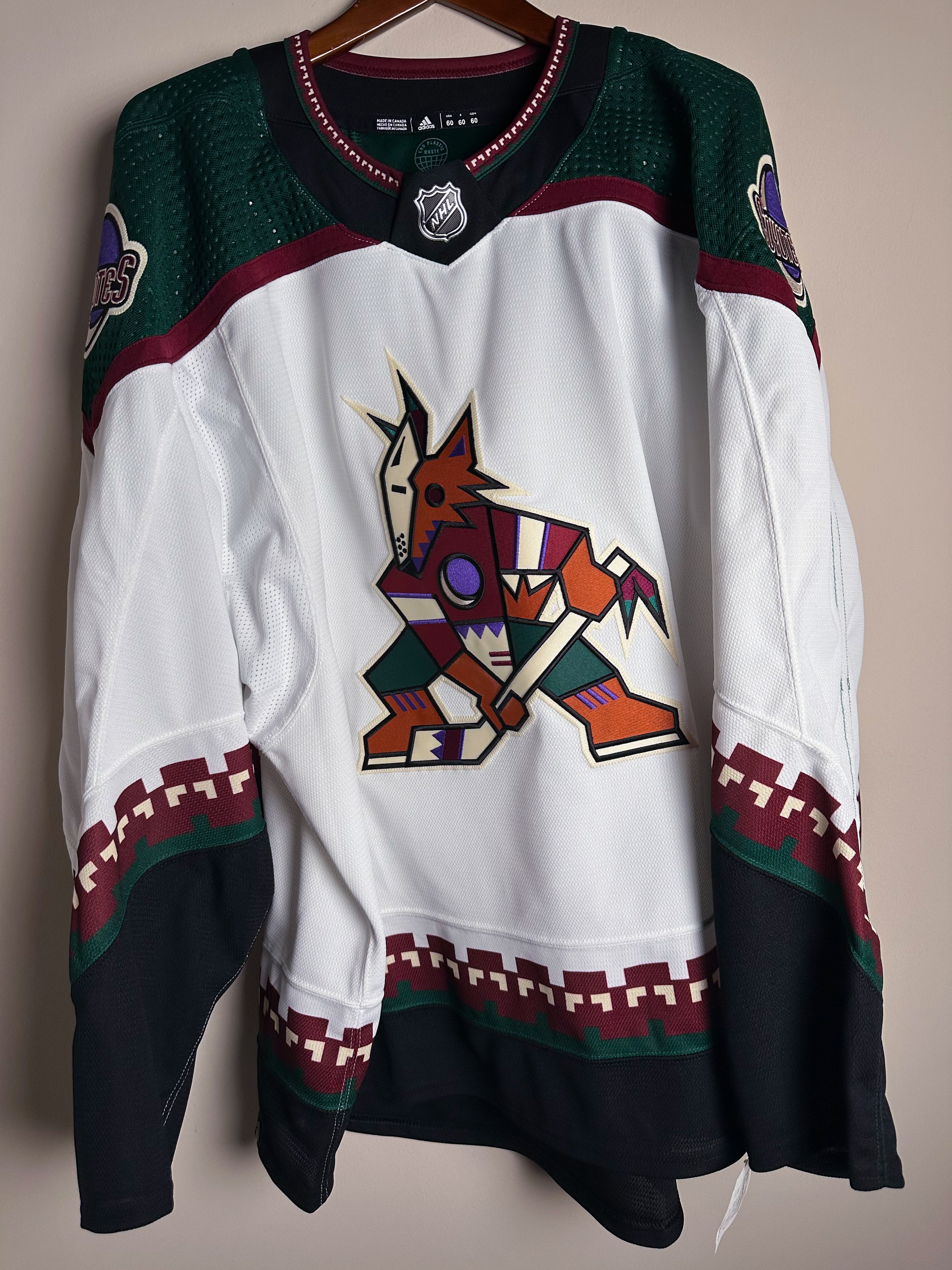 Brand New  Size: 60G   100% polyester  Officially licensed by the NHL  Made by Adidas  Relaxed Fit  Crewneck  Arizona Coyotes Crest  White/Green/Black/Burgundy   Steal at this price!  No refund if tag is removed