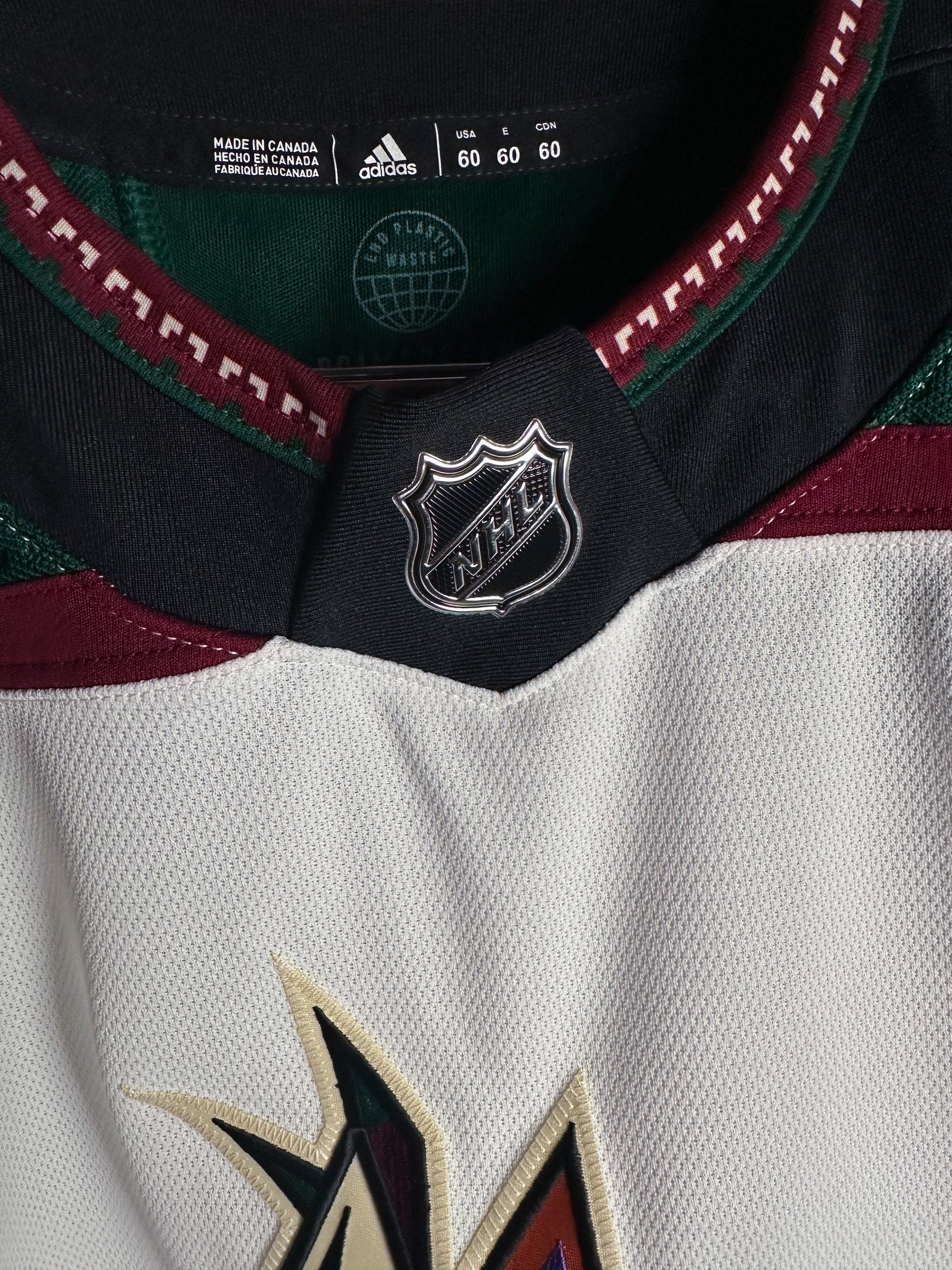 Brand New  Size: 60G   100% polyester  Officially licensed by the NHL  Made by Adidas  Relaxed Fit  Crewneck  Arizona Coyotes Crest  White/Green/Black/Burgundy   Steal at this price!  No refund if tag is removed