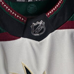 Brand New  Size: 60G   100% polyester  Officially licensed by the NHL  Made by Adidas  Relaxed Fit  Crewneck  Arizona Coyotes Crest  White/Green/Black/Burgundy   Steal at this price!  No refund if tag is removed